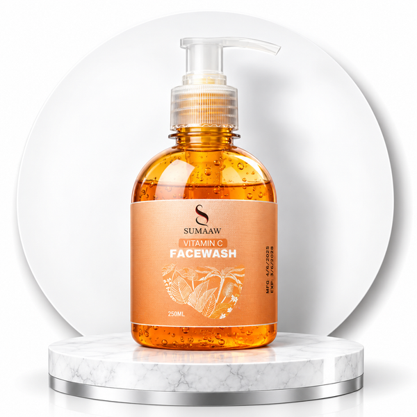 A bottle of Sumaaaw Vitamin Facewash with a clear pump dispenser, filled with orange-colored liquid.